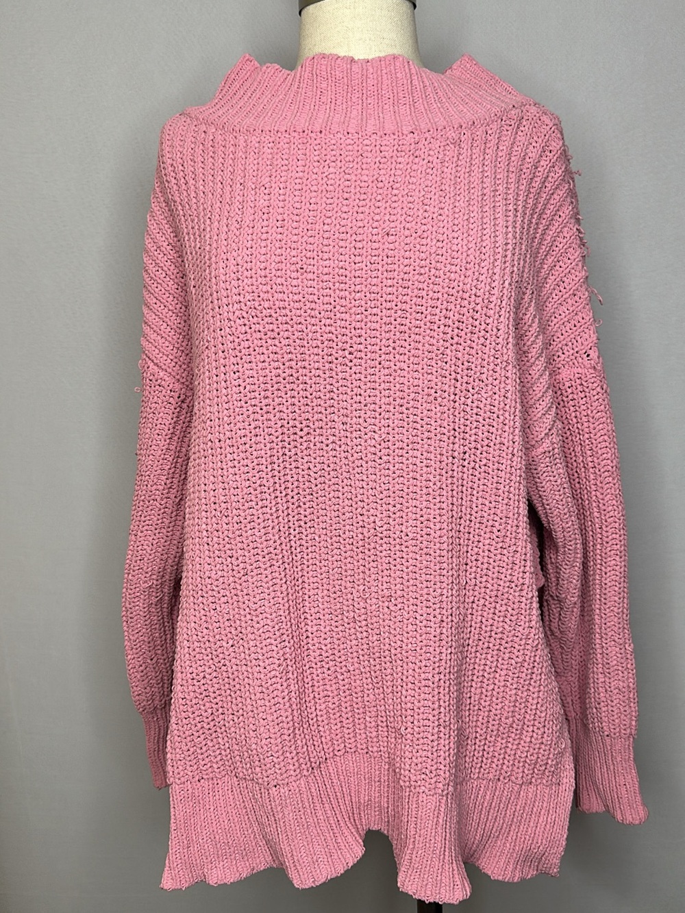 Pink frayed looking sweater with slit on the sides